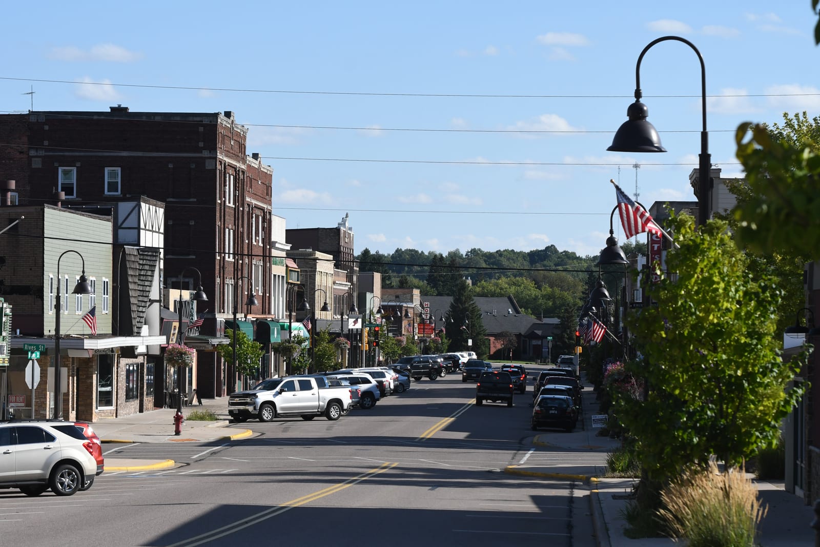 A lively street view of downtown Rhinelander with shops and dining options.