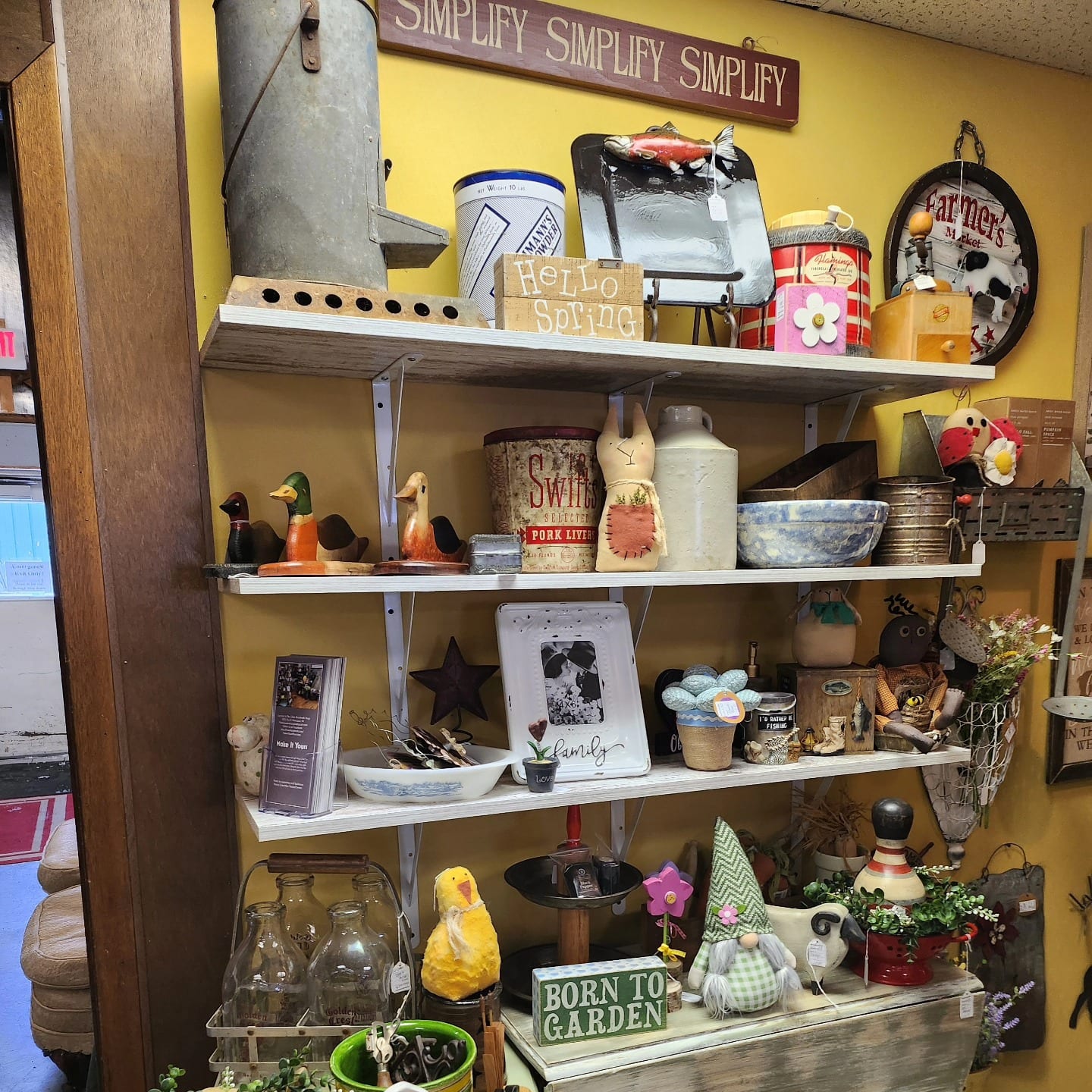 Interior view of a local craft store with shelves displaying various handmade items and decorations.