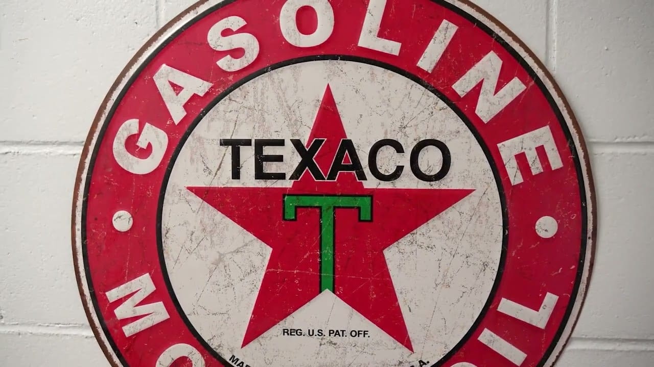 Close-up view of a vintage Texaco gasoline sign with a red star and green T